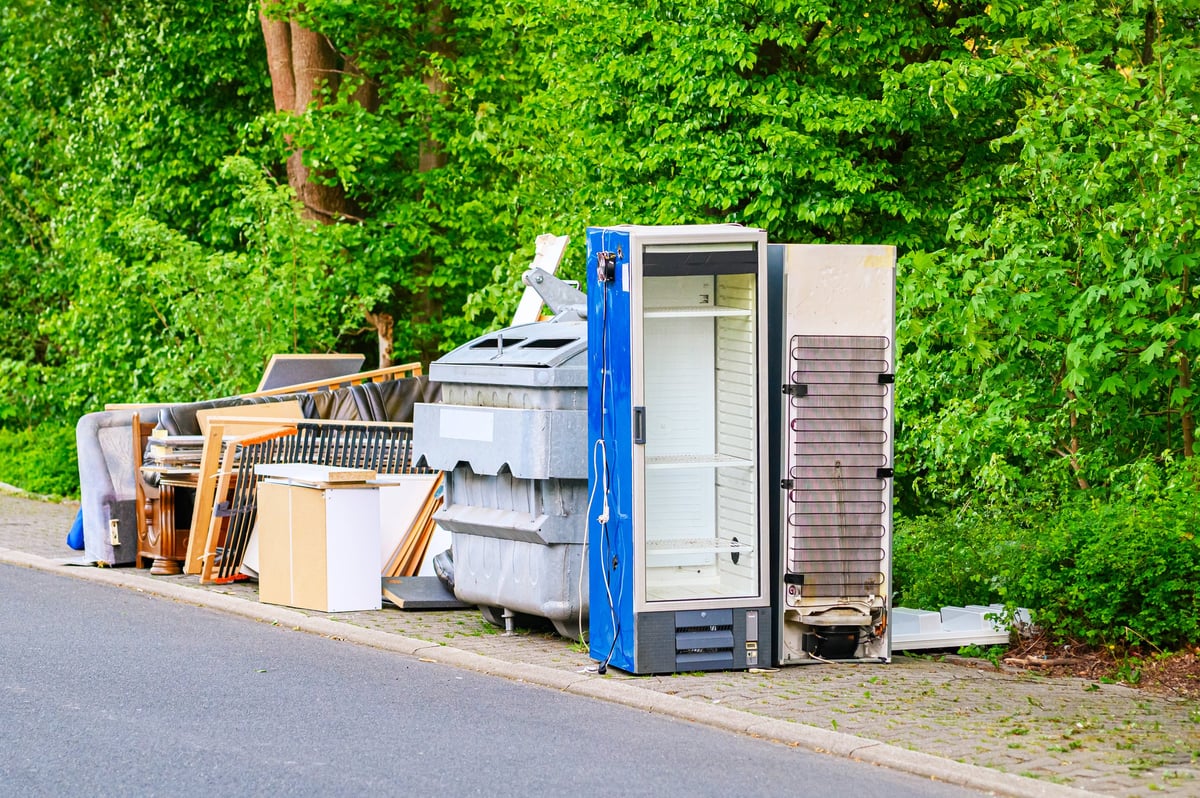 Large pile of discarded household appliances and furniture